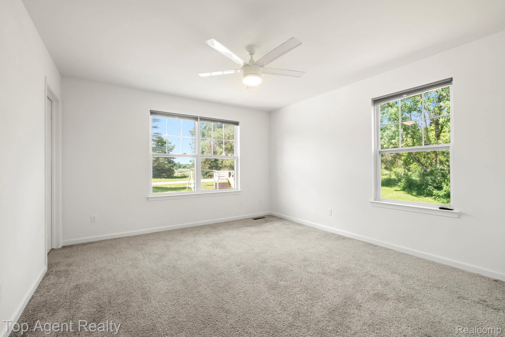 63770 Dequindre Road Washington, MI 48095 - Photo 30 of 61 Bright interior space featuring light gray carpeting and white walls