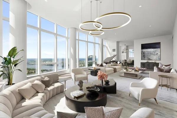 a living room with furniture potted plant and a large window