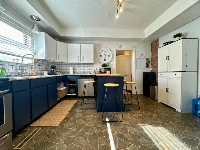 a kitchen with a sink stove and refrigerator
