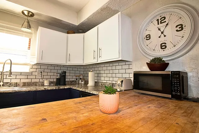 a kitchen with a stove and a white refrigerator