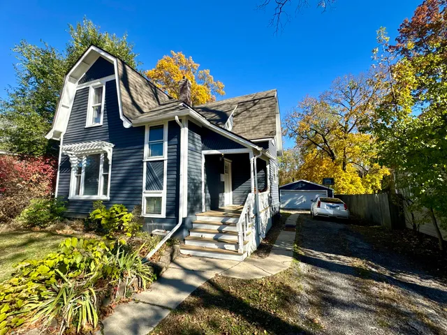 a view of house with outdoor space and sitting area