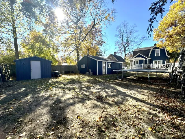 a backyard of a house with table and chairs