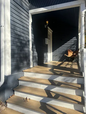 a view of staircase with white walls and railing