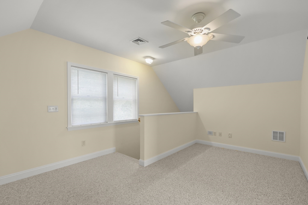 2 Tricia Road Falmouth, MA 02556 - Photo 31 of 39 an empty room with chandelier fan and windows