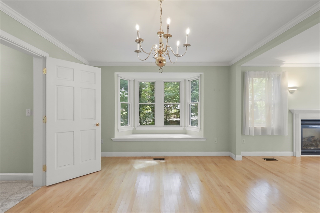 2 Tricia Road Falmouth, MA 02556 - Photo 9 of 39 a view of an empty room with a window and wooden floor
