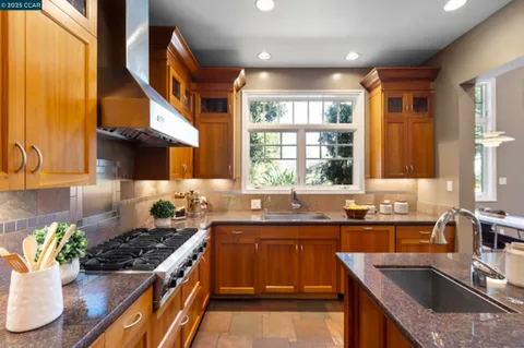 a kitchen with stainless steel appliances granite countertop a stove and a refrigerator
