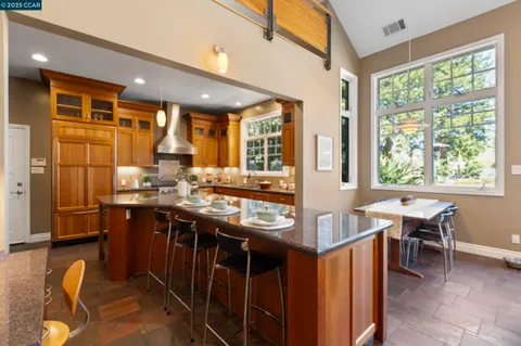 a living room with furniture fireplace and a large window