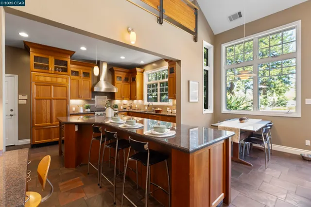 a living room with furniture fireplace and a large window