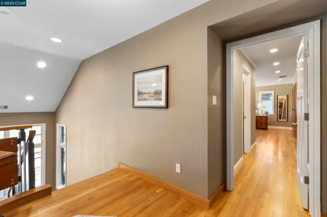 a bedroom with a bed lamp and a large window