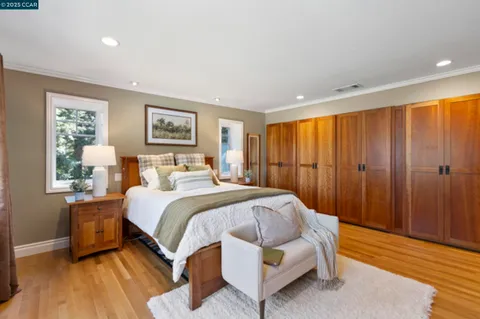 a bed room with a bed and a large window