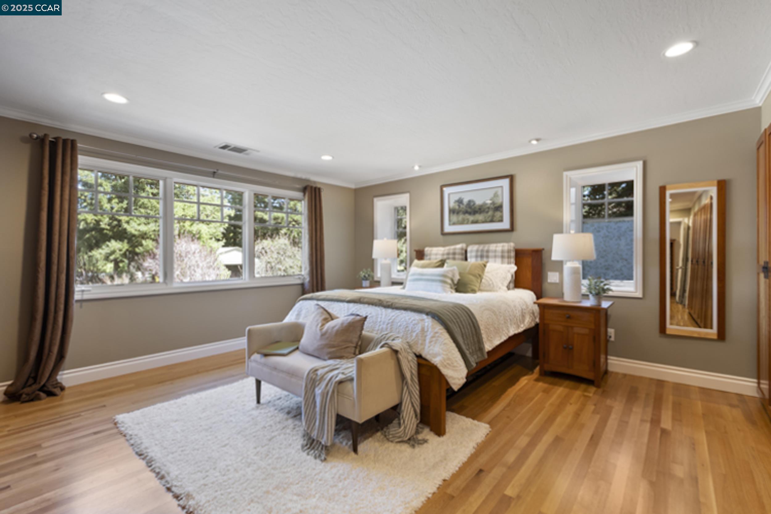 350 Pine Creek Road Walnut Creek, CA 94598 - Photo 26 of 59 a spacious bedroom with a bed and wooden floor