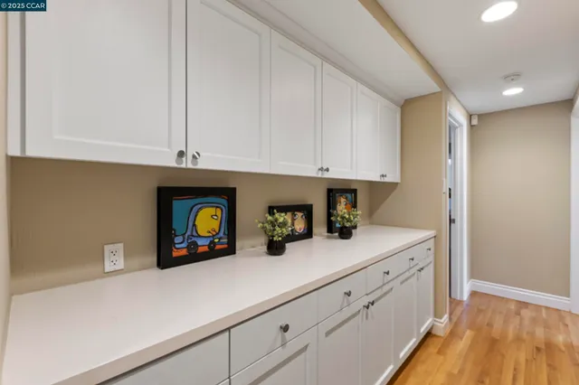 a bathroom with a granite countertop double vanity sink and mirror
