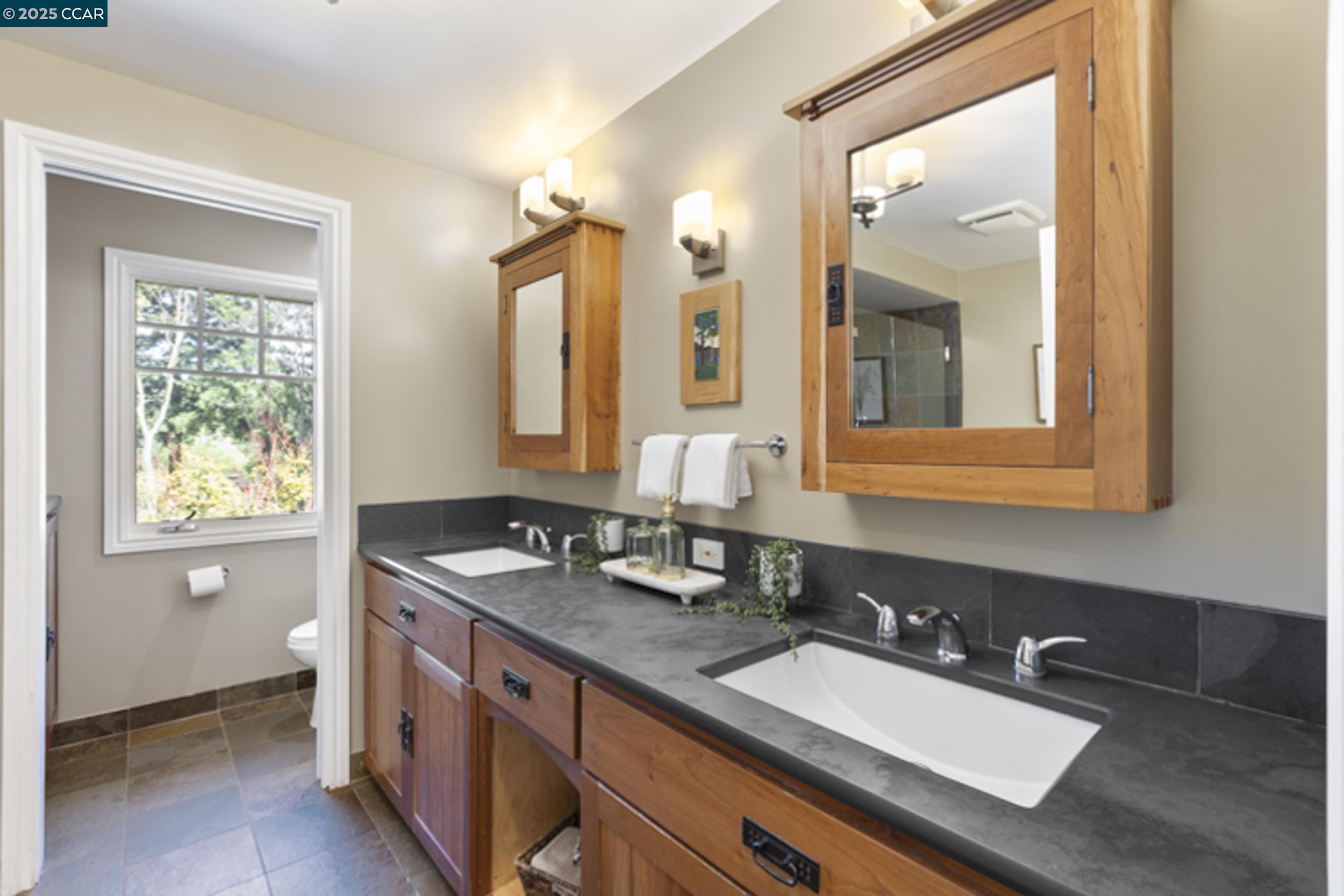 350 Pine Creek Road Walnut Creek, CA 94598 - Photo 28 of 59 a bathroom with a granite countertop double vanity sink and mirror