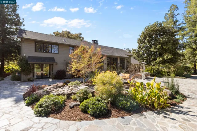 a view of a house with swimming pool and sitting area