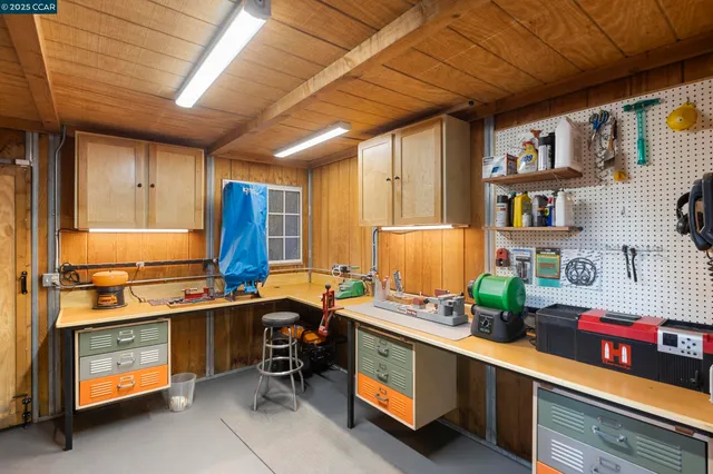 a view of swimming pool with chairs and trees