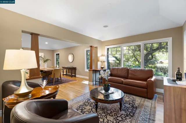 a view of a livingroom with wooden floor and furniture