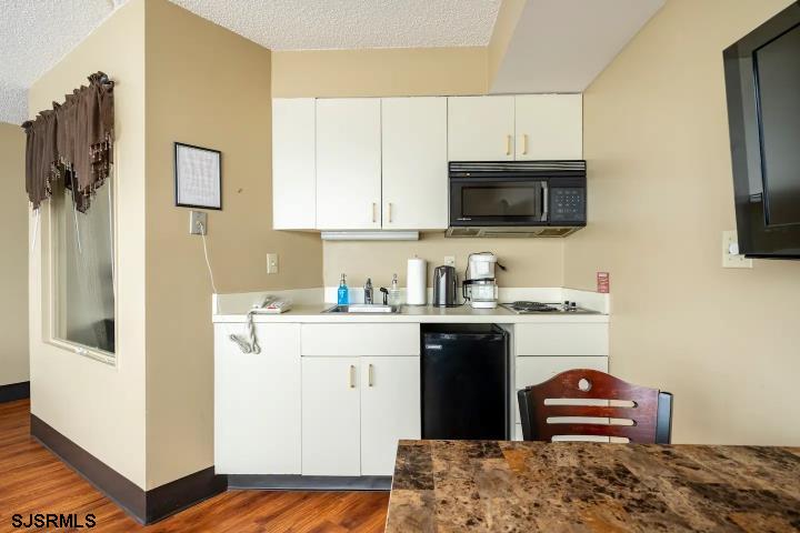 1515 Boardwalk, Unit 2704 Atlantic City, NJ 08401 - Photo 11 of 15 a kitchen with a sink and a stove top oven