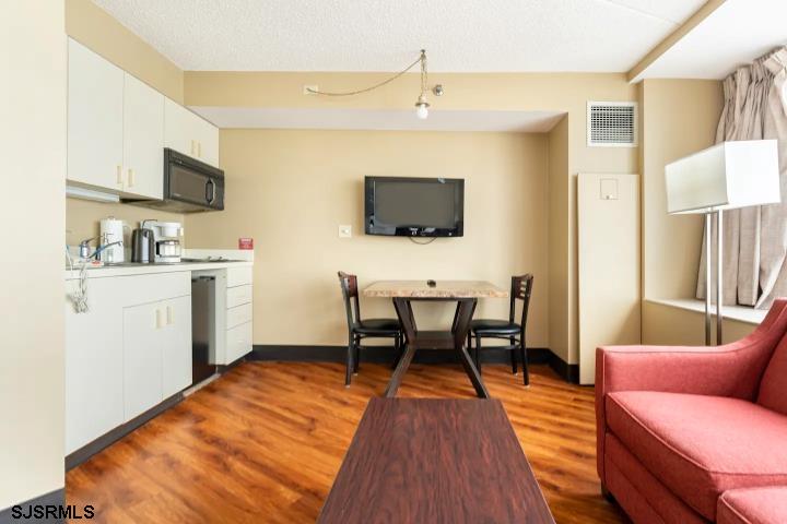 1515 Boardwalk, Unit 2704 Atlantic City, NJ 08401 - Photo 13 of 15 a work room with furniture a flat screen tv and kitchen view