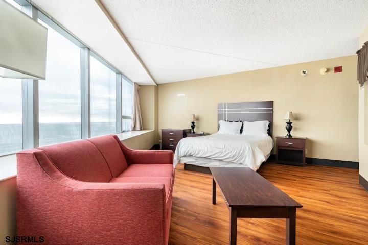 1515 Boardwalk, Unit 2704 Atlantic City, NJ 08401 - Photo 3 of 15 a bedroom with a bed and wooden floor