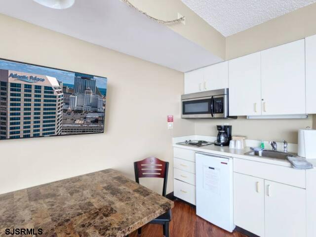 1515 Boardwalk, Unit 2704 Atlantic City, NJ 08401 - Photo 4 of 15 a kitchen with stainless steel appliances granite countertop a sink stove and microwave