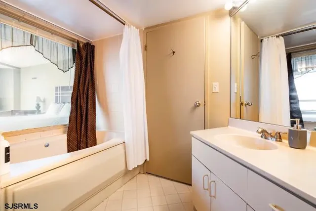 a bathroom with a sink a mirror and a shower