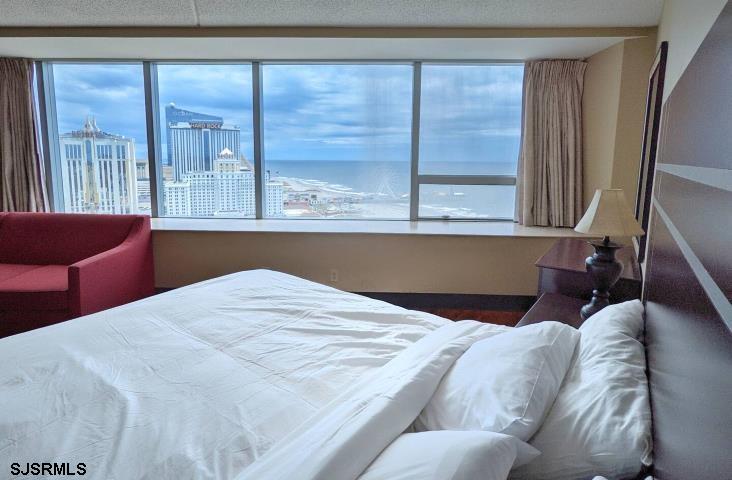 1515 Boardwalk, Unit 2704 Atlantic City, NJ 08401 - Photo 9 of 15 a bed sitting in a bedroom next to a window