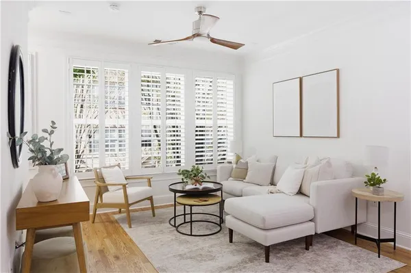 a living room with furniture a window and a chandelier
