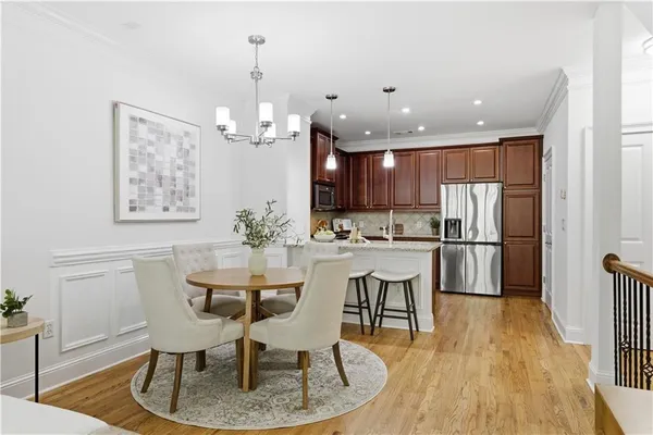 a kitchen with granite countertop a refrigerator and a sink