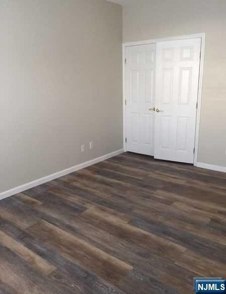 2 Richmond Road, Unit 110 West Milford, NJ 07480 - Photo 12 of 45 a view of an empty room with wooden floor