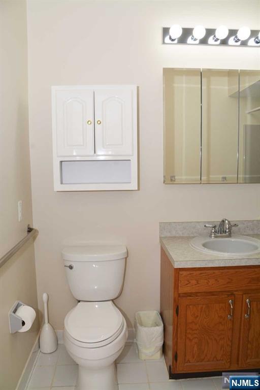 2 Richmond Road, Unit 110 West Milford, NJ 07480 - Photo 15 of 45 a bathroom with a toilet a sink a vanity and mirror