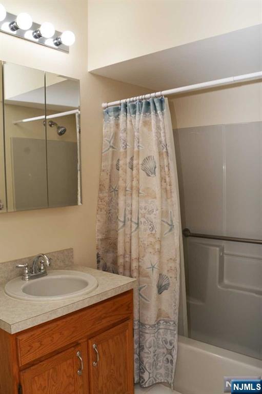 2 Richmond Road, Unit 110 West Milford, NJ 07480 - Photo 18 of 45 a bathroom with a granite countertop sink and a mirror