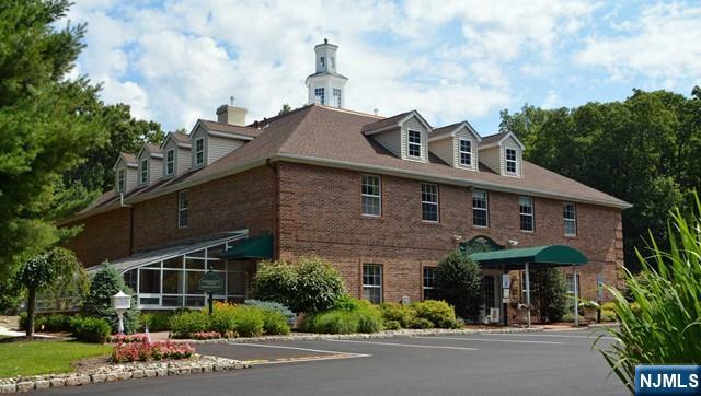 2 Richmond Road, Unit 110 West Milford, NJ 07480 - Photo 30 of 45 a front view of a house with yard and trees