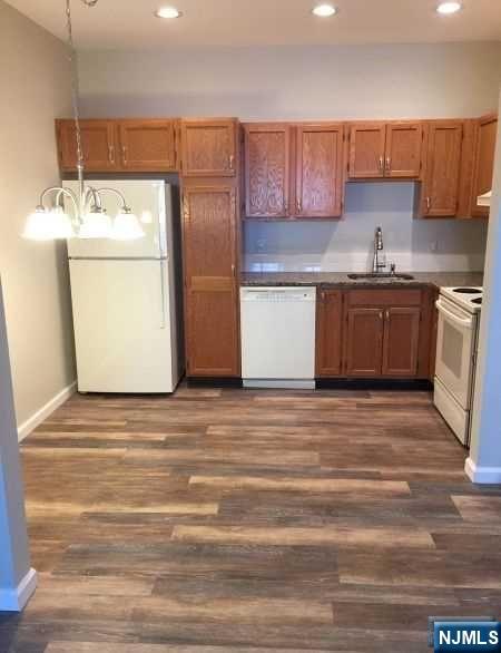 2 Richmond Road, Unit 110 West Milford, NJ 07480 - Photo 3 of 45 a kitchen with stainless steel appliances granite countertop a refrigerator and a stove top oven