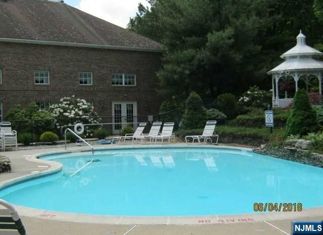 2 Richmond Road, Unit 110 West Milford, NJ 07480 - Photo 32 of 45 a view of a house with swimming pool and sitting area