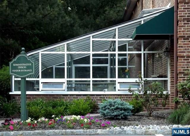 2 Richmond Road, Unit 110 West Milford, NJ 07480 - Photo 44 of 45 a house with a flower garden in front of it