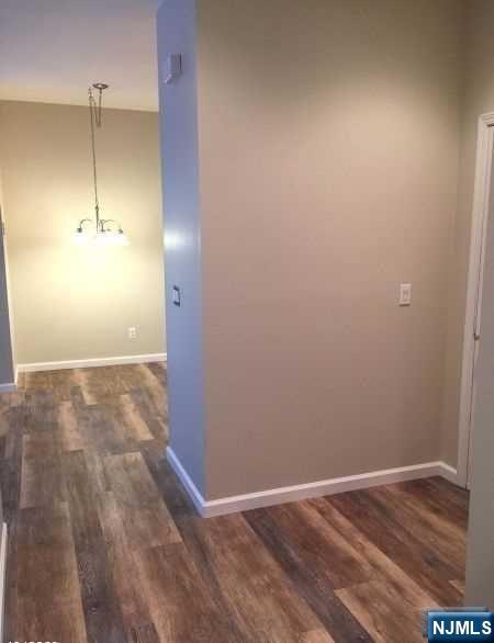 2 Richmond Road, Unit 110 West Milford, NJ 07480 - Photo 9 of 45 a view of an empty room with wooden floor