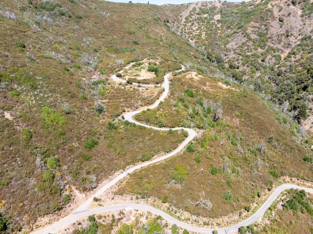 a view of a large mountain with mountains in the background