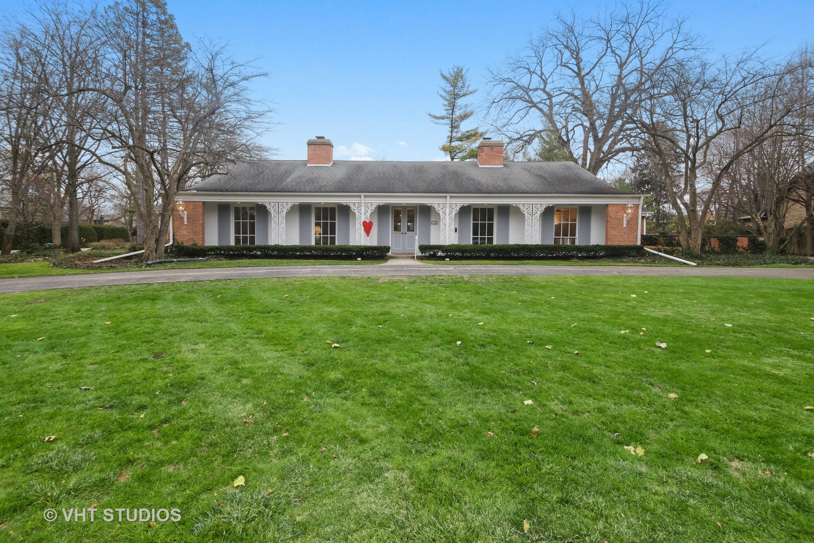 1122 Mohawk Road Wilmette, IL 60091 - Photo 1 of 23 a front view of a house with yard and green space