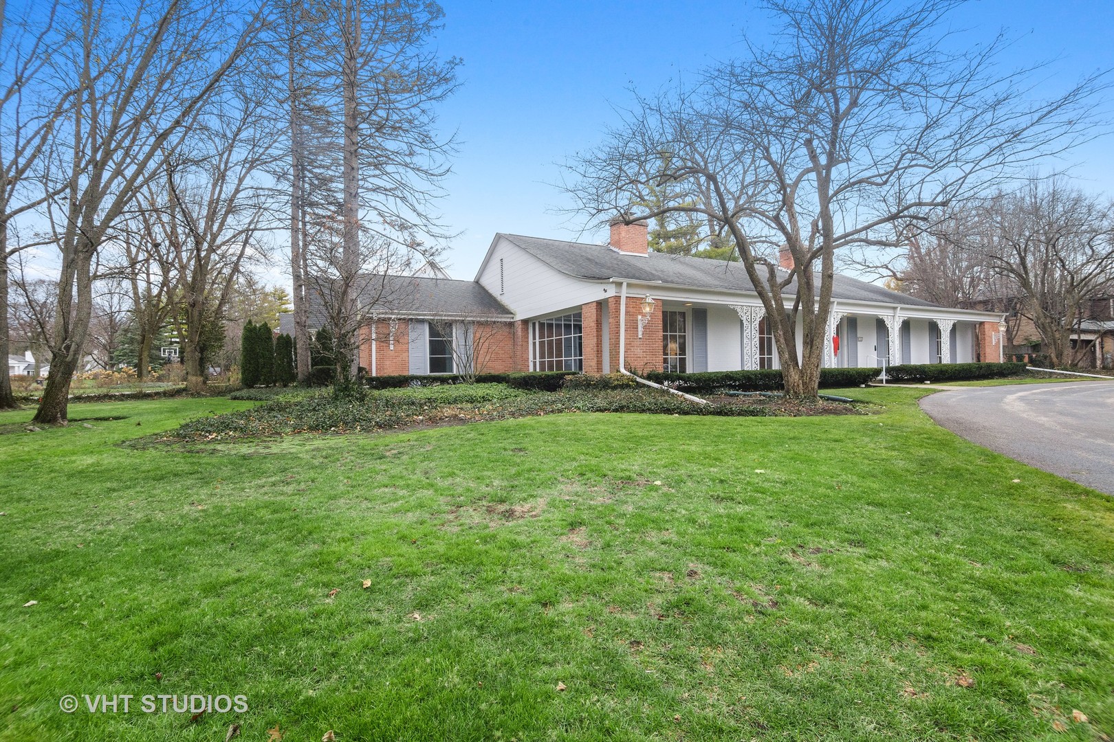 1122 Mohawk Road Wilmette, IL 60091 - Photo 2 of 23 a front view of a house with a yard and trees