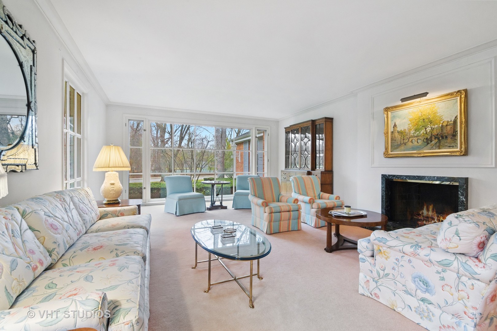 1122 Mohawk Road Wilmette, IL 60091 - Photo 5 of 23 a living room with furniture two large windows and a fireplace