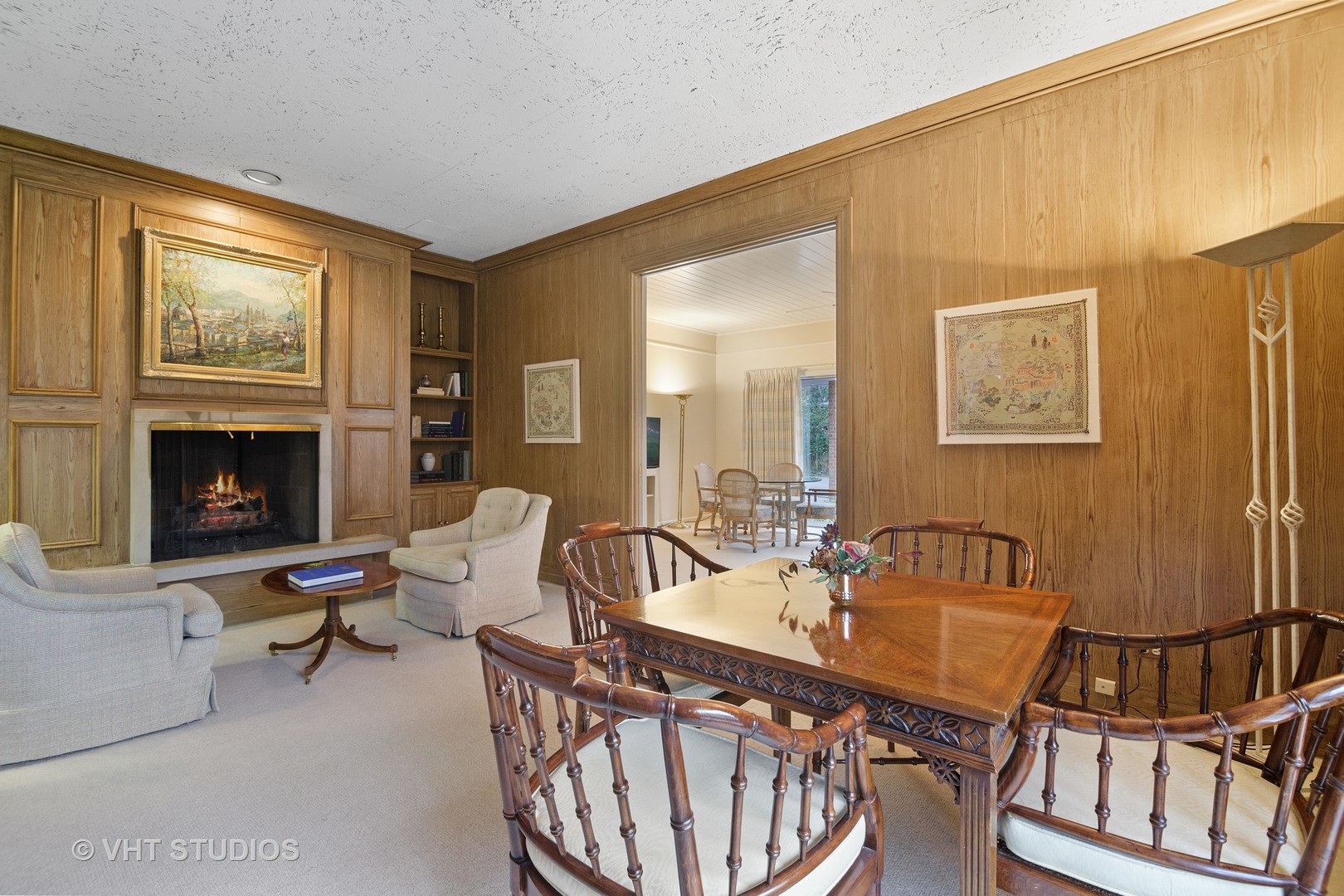 1122 Mohawk Road Wilmette, IL 60091 - Photo 7 of 23 a living room with furniture a fireplace and a flat screen tv