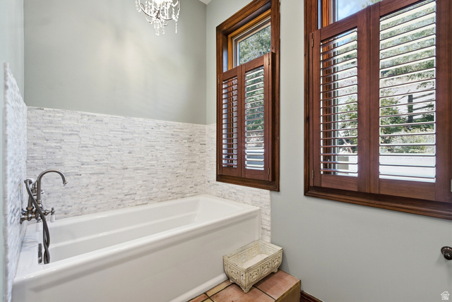335 Bern Way Midway, UT 84049 - Photo 72 of 88 Built-in soaking tub featuring a decorative wall tile surround and vintage-style fixtures