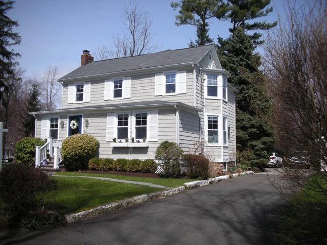 67 Relihan Road Darien, CT 06820 - Photo 21 of 25 a front view of a house with a yard and garage