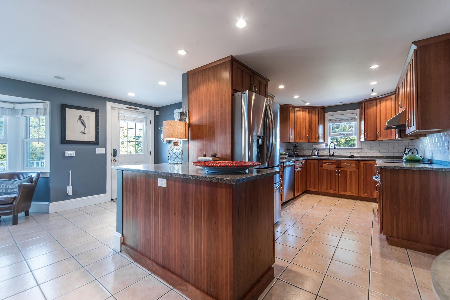 67 Relihan Road Darien, CT 06820 - Photo 7 of 25 a kitchen with stainless steel appliances granite countertop a stove a sink a refrigerator and a wooden cabinets