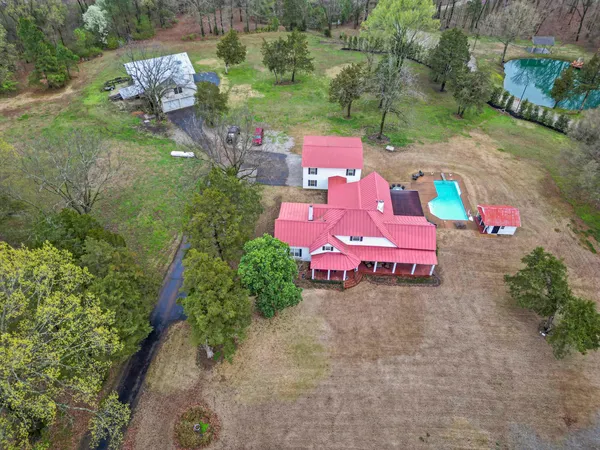 a view of a livingroom with furniture wooden floor a chandelier