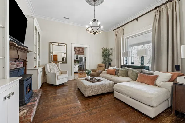 a front view of a house with a yard and trees