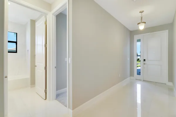 a bathroom with a granite countertop sink two mirror and a bathtub