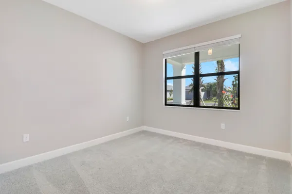 a large white kitchen with granite countertop white cabinets and a granite counter tops