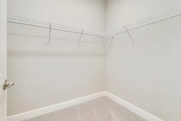 a large white kitchen with stainless steel appliances granite countertop a stove and a sink