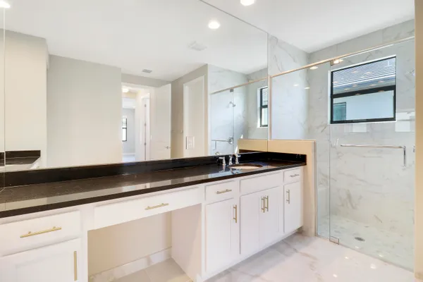 a kitchen with a refrigerator and a stove top oven
